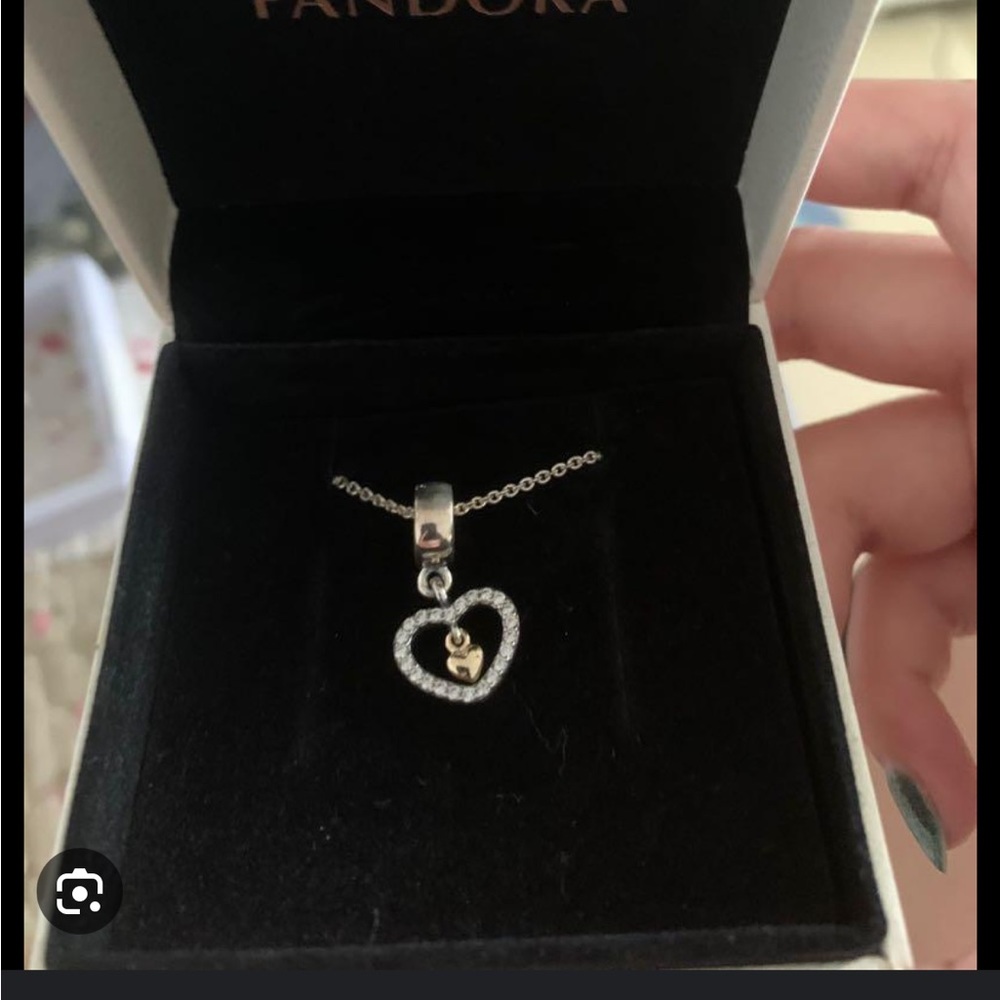Retired pandora charm- dancing heart.